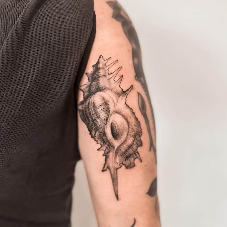3. An alabaster shell tattoo on the upper arm