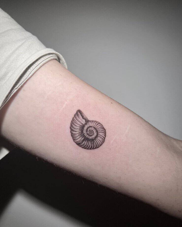 8. An ammonite shell tattoo on the bicep