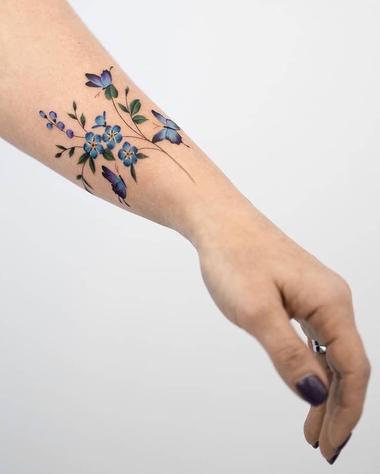 Blue butterflies and forget me nots tattoo