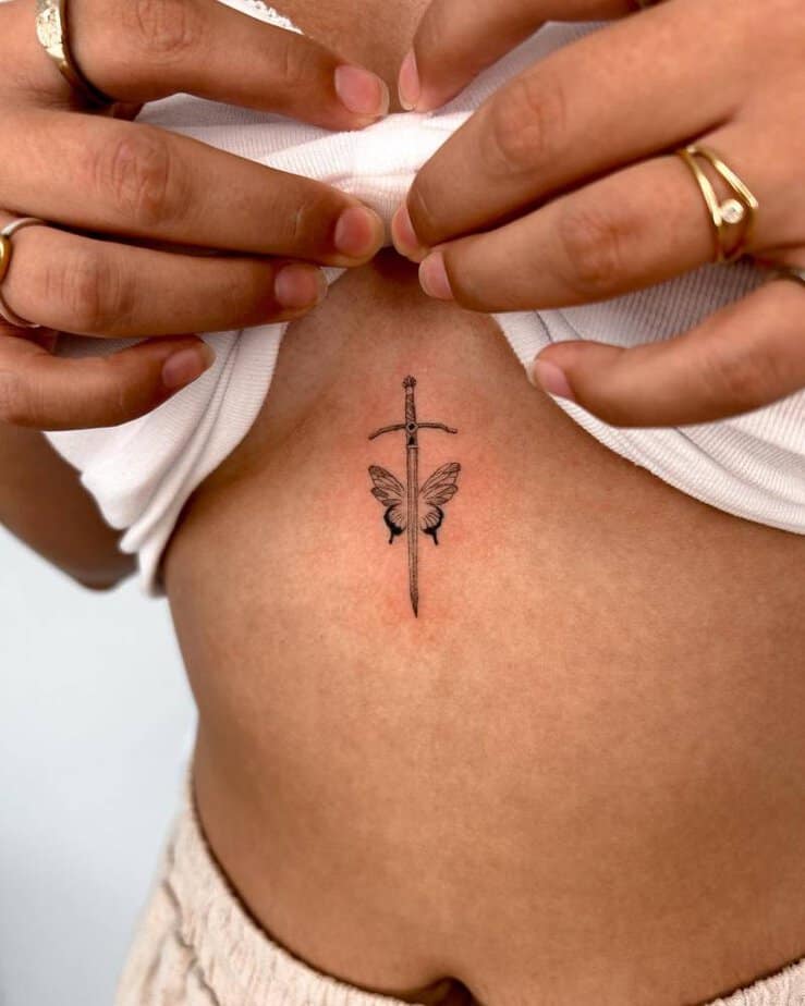 Butterfly and sword sternum tattoo