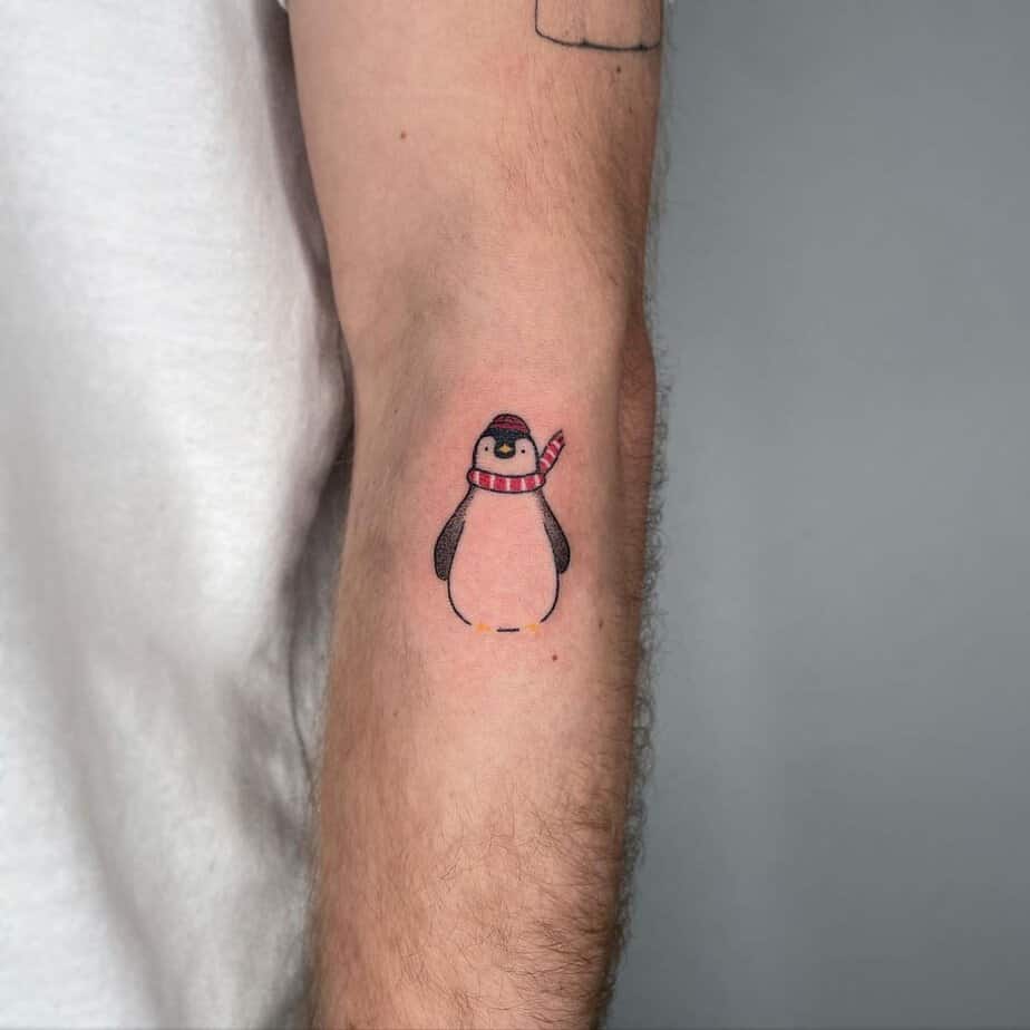 Cartoon-like penguin tattoos 3