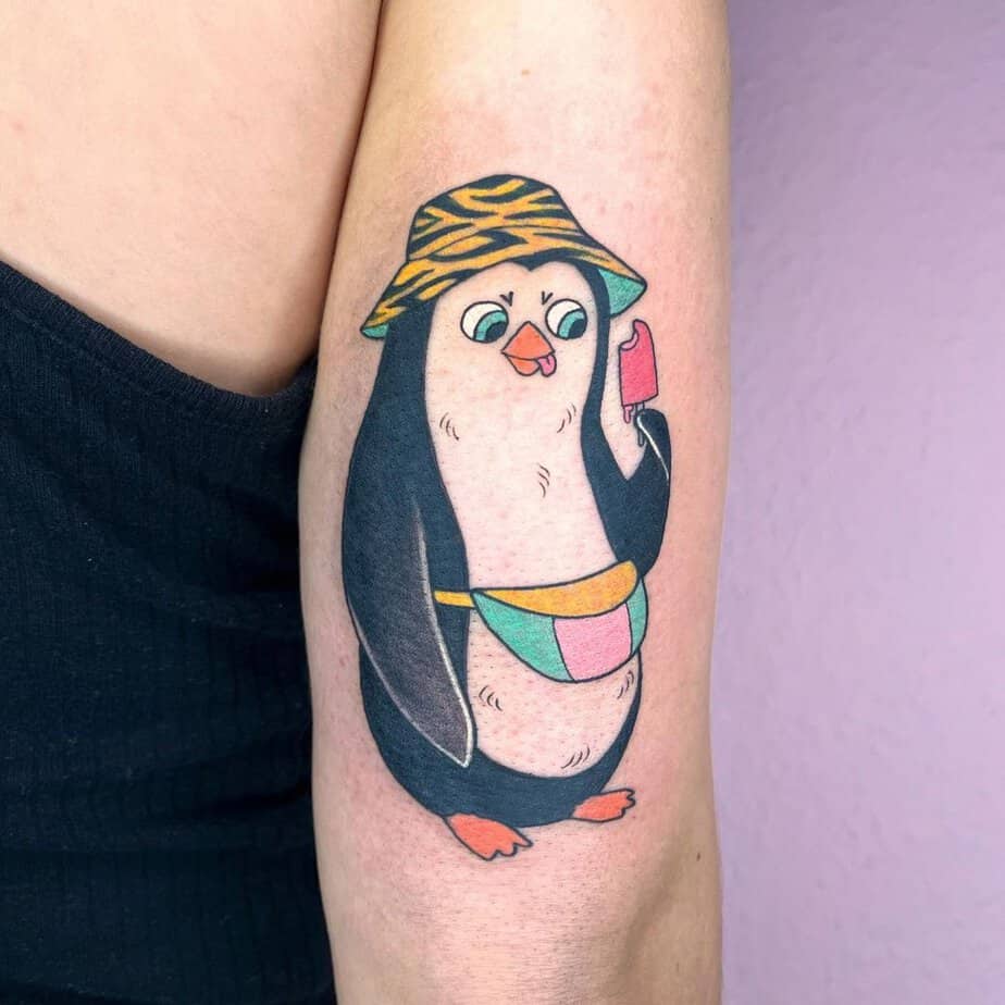 Cartoon-like penguin tattoos 4