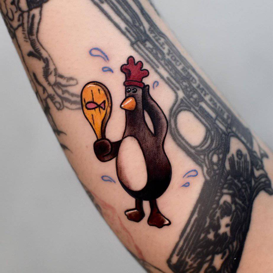 Cartoon-like penguin tattoos 5