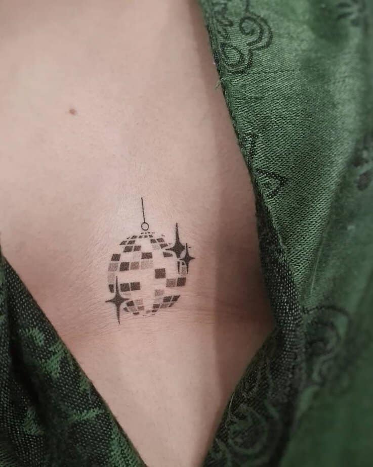Disco ball sternum tattoo