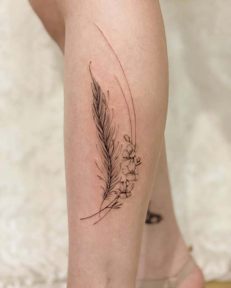 Feather and apple blossom tattoo
