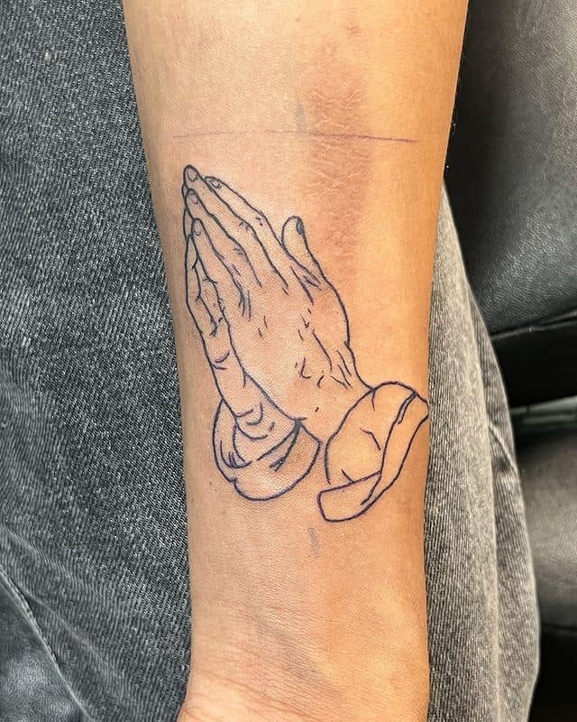 Fine-line praying hands tattoo