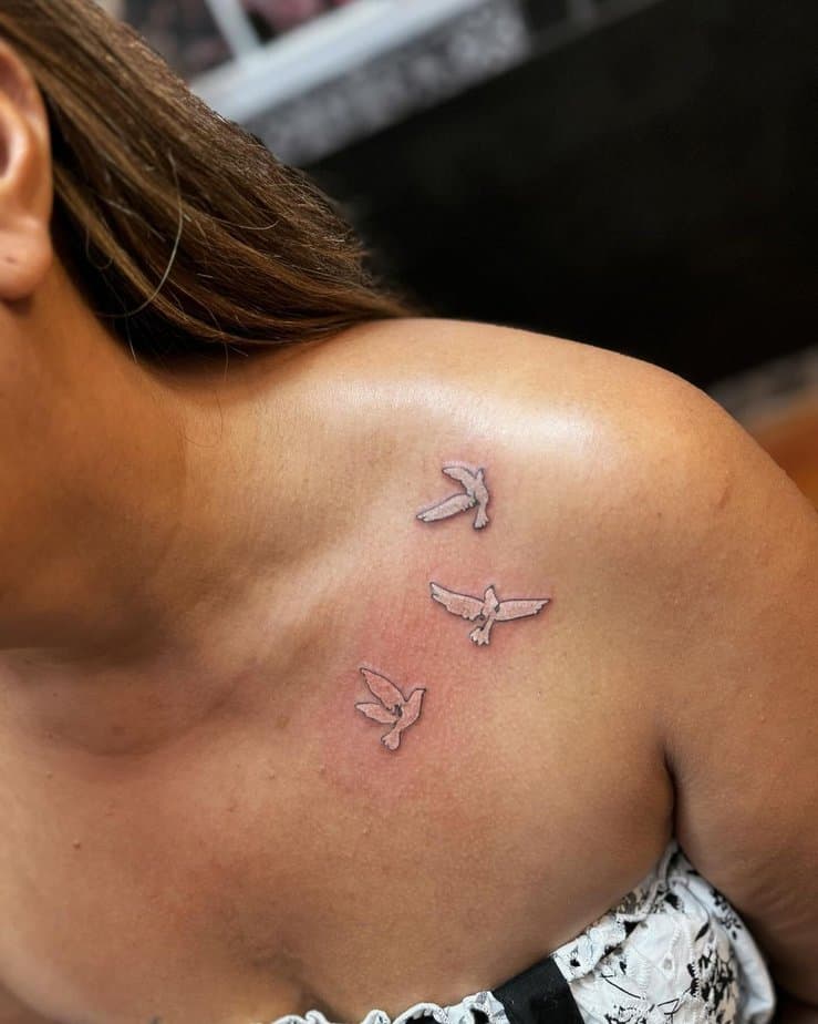 Flying doves collarbone tattoo