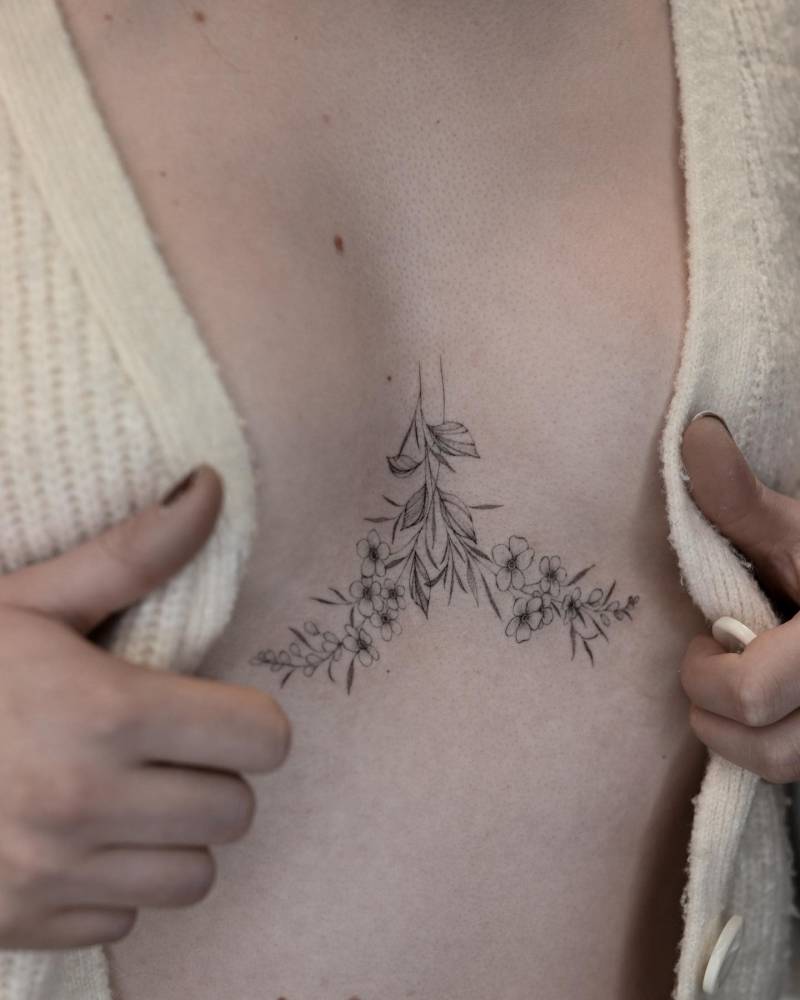 Forget-me-not flowers sternum tattoo
