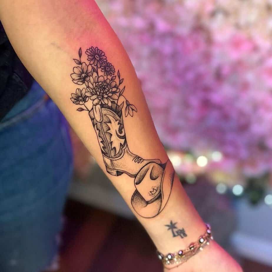 19. A tattoo of a cowboy boot and a cowboy hat