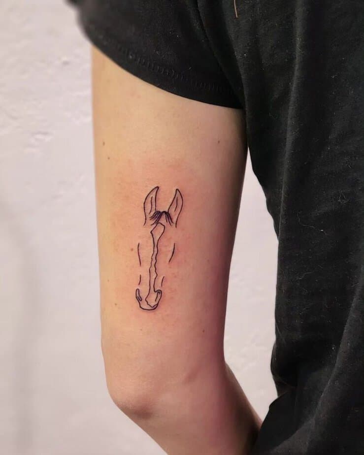 6. A line art horse tattoo 