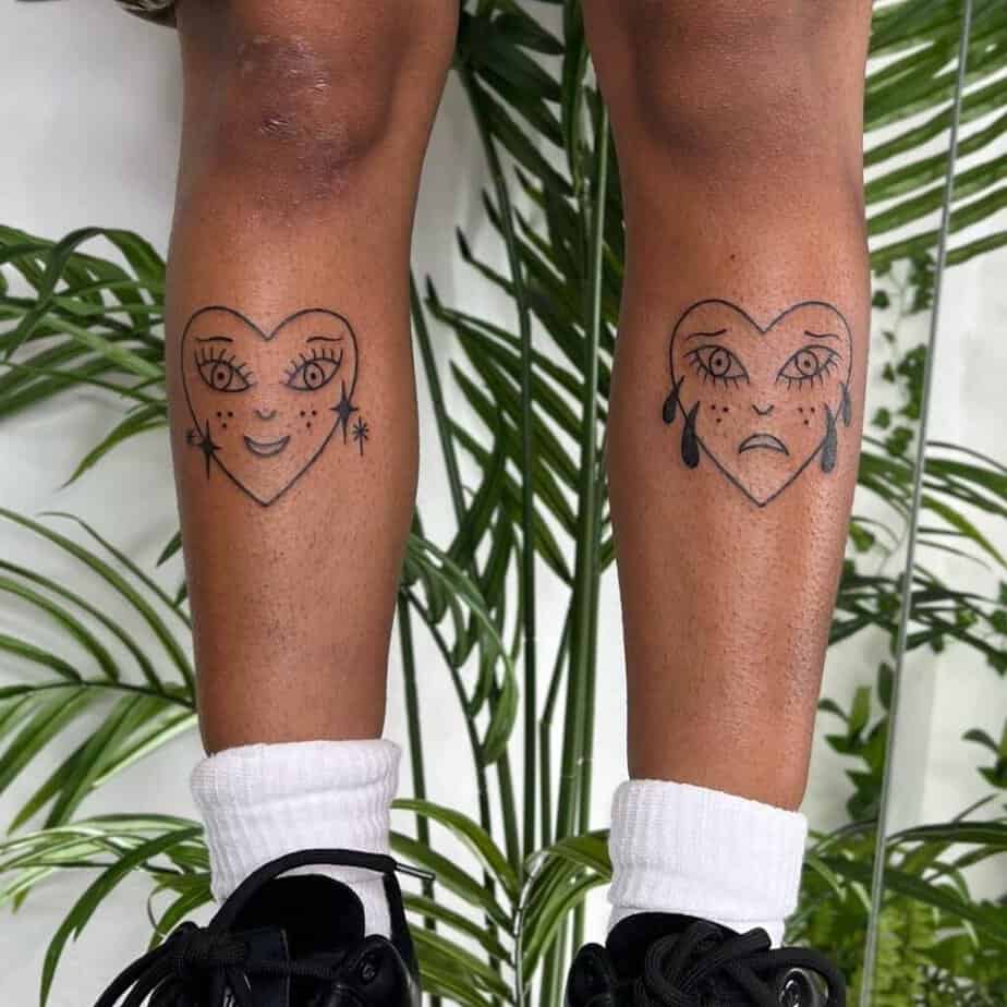 20. A smiling heart and a crying heart tattoo