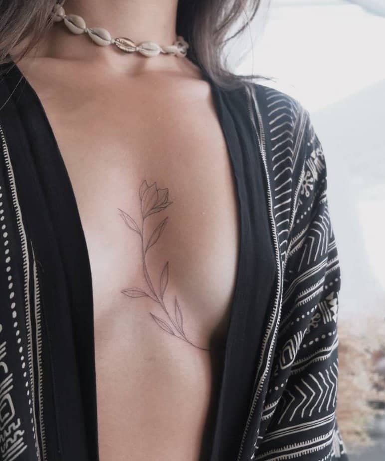 Lily flower sternum tattoo