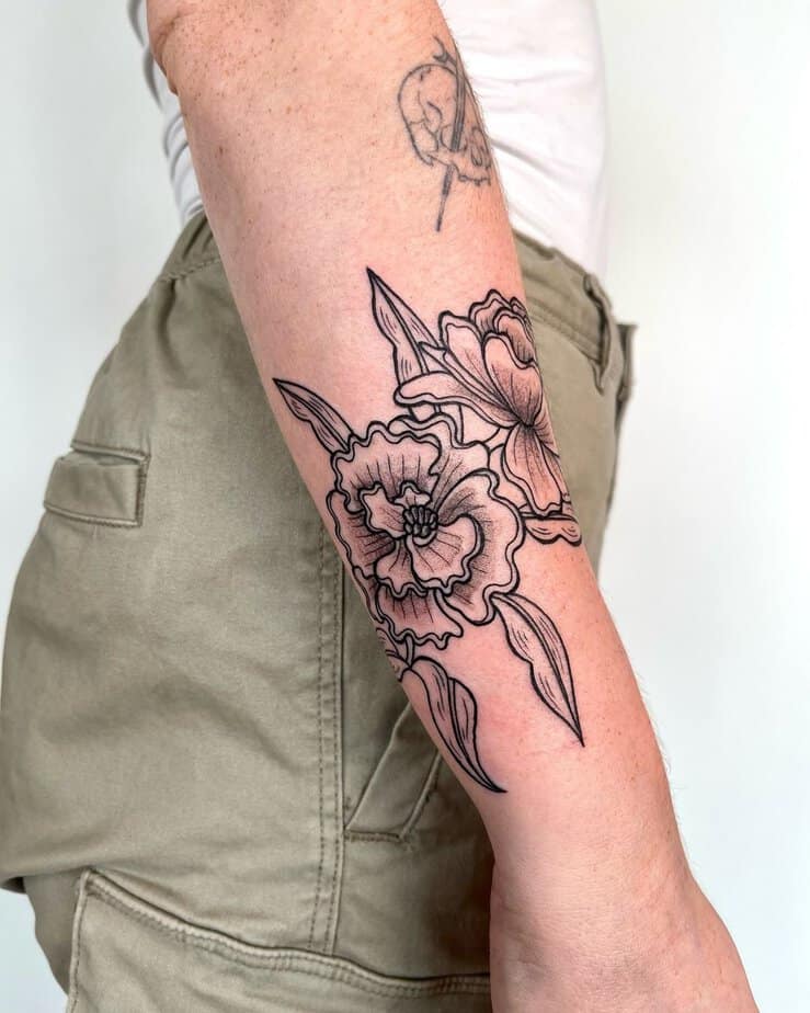 Black and gray marigold forearm tattoo