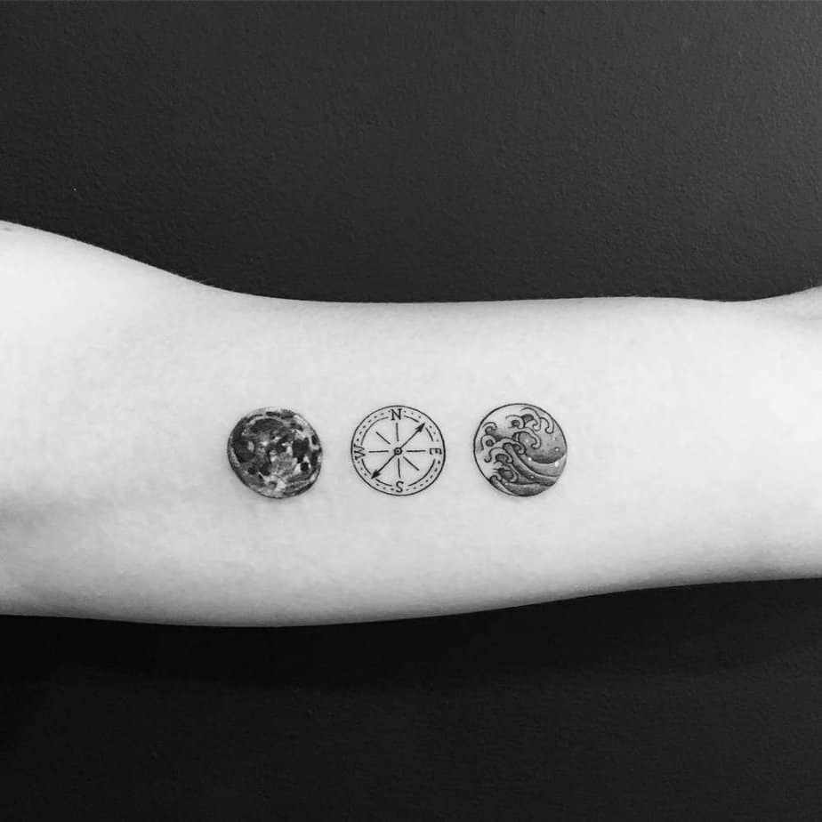 Moon, compass, and waves circle tattoo