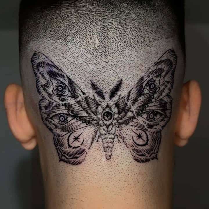 Moth tattoo on the back of the head