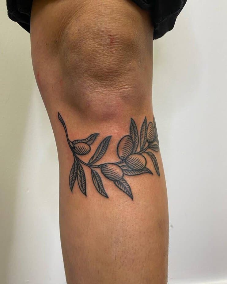 Olive branch tattoo on the shin