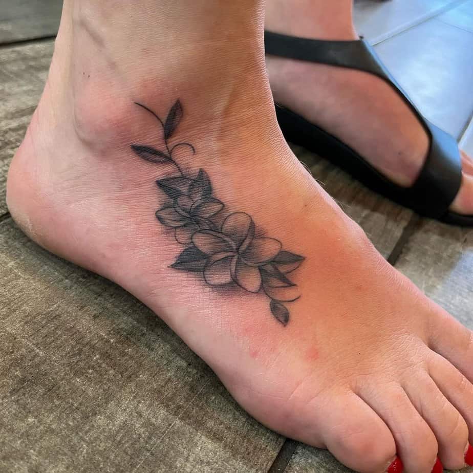 Plumeria foot design tattoo