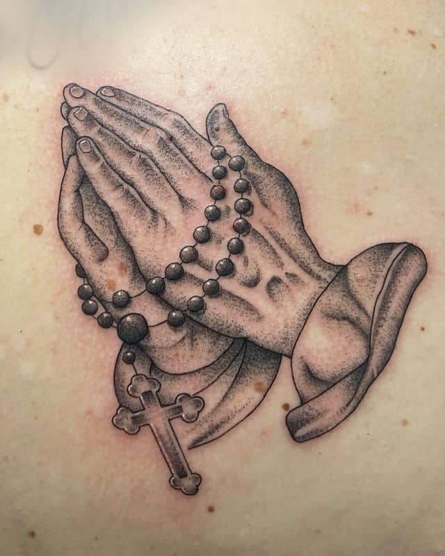 Praying hands tattoo