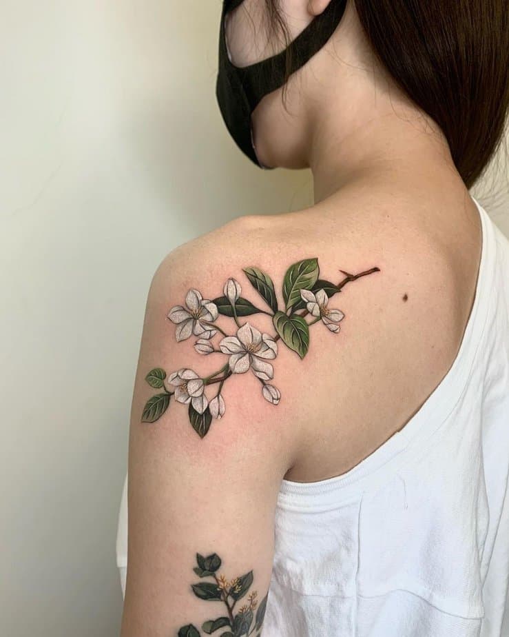 Realistic apple blossom tattoo
