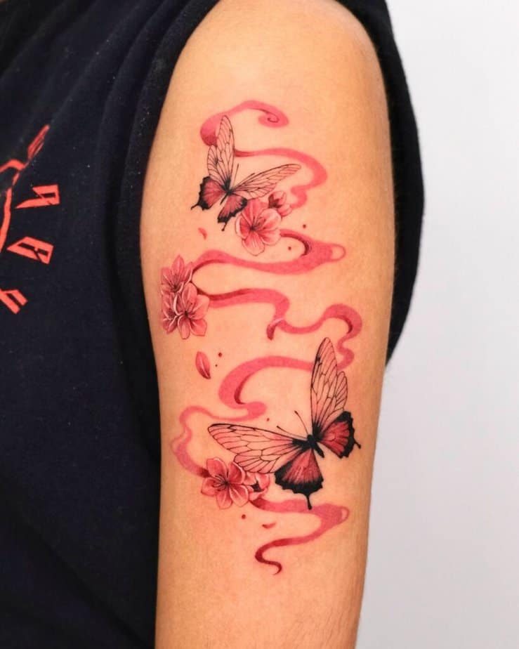 23. A red butterfly tattoo with smoke and sakura 