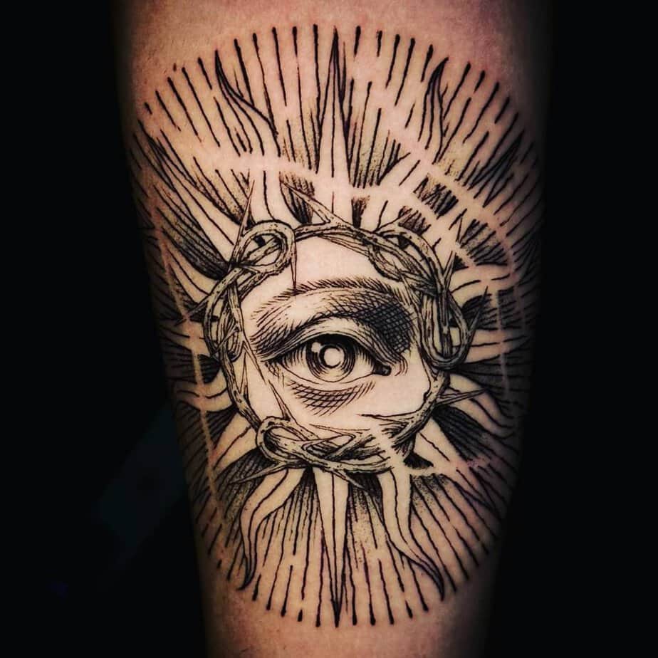 Sun and eye forearm tattoo
