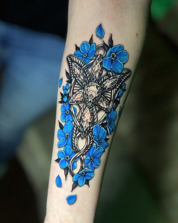 Realistic Evenstar pendant surrounded by blue anemone flowers